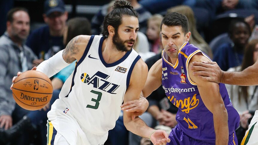 Ricky Rubio dribbles as Kevin Lisch tries to defend.