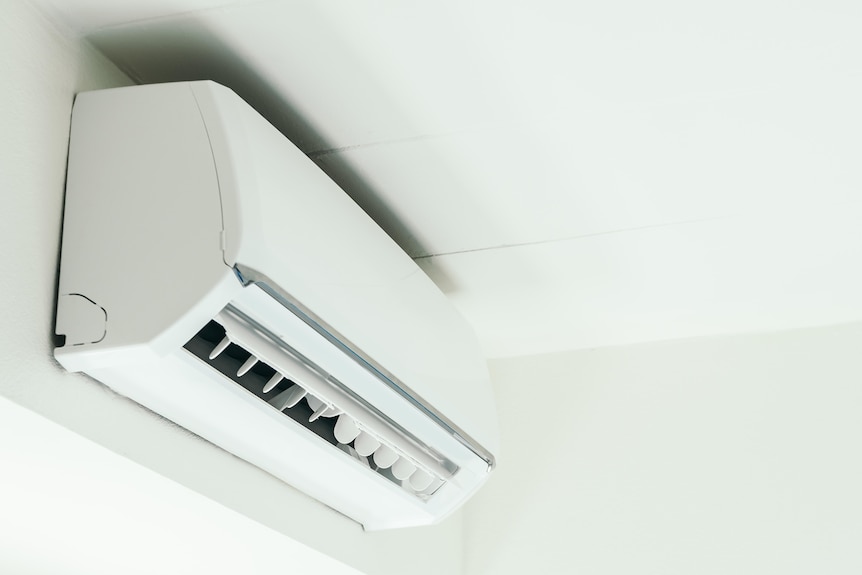 A white aircon on a ceiling 