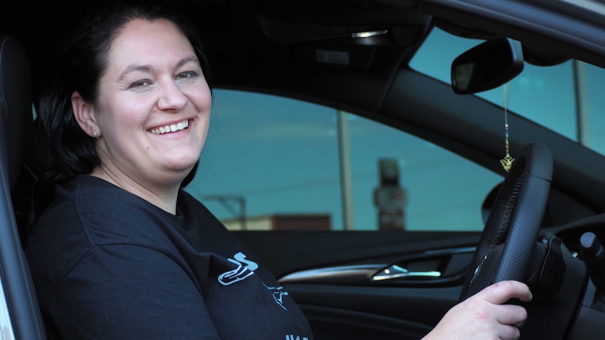 Cara Bertoli sitting in the driver seat of her new Holden Commodore