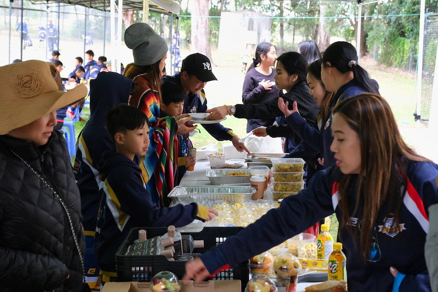 People share food around a table