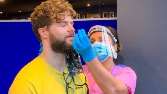 A man gets a swab in his nose for a COVID-19 test