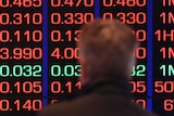 A man watches information screens at the ASX