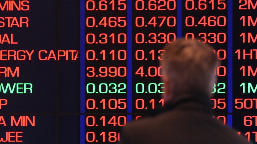 A man watches the information screens at the ASX