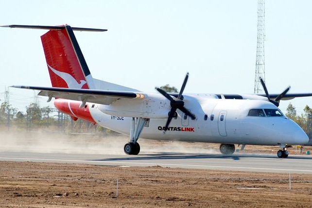 A Qantaslink plane lands.