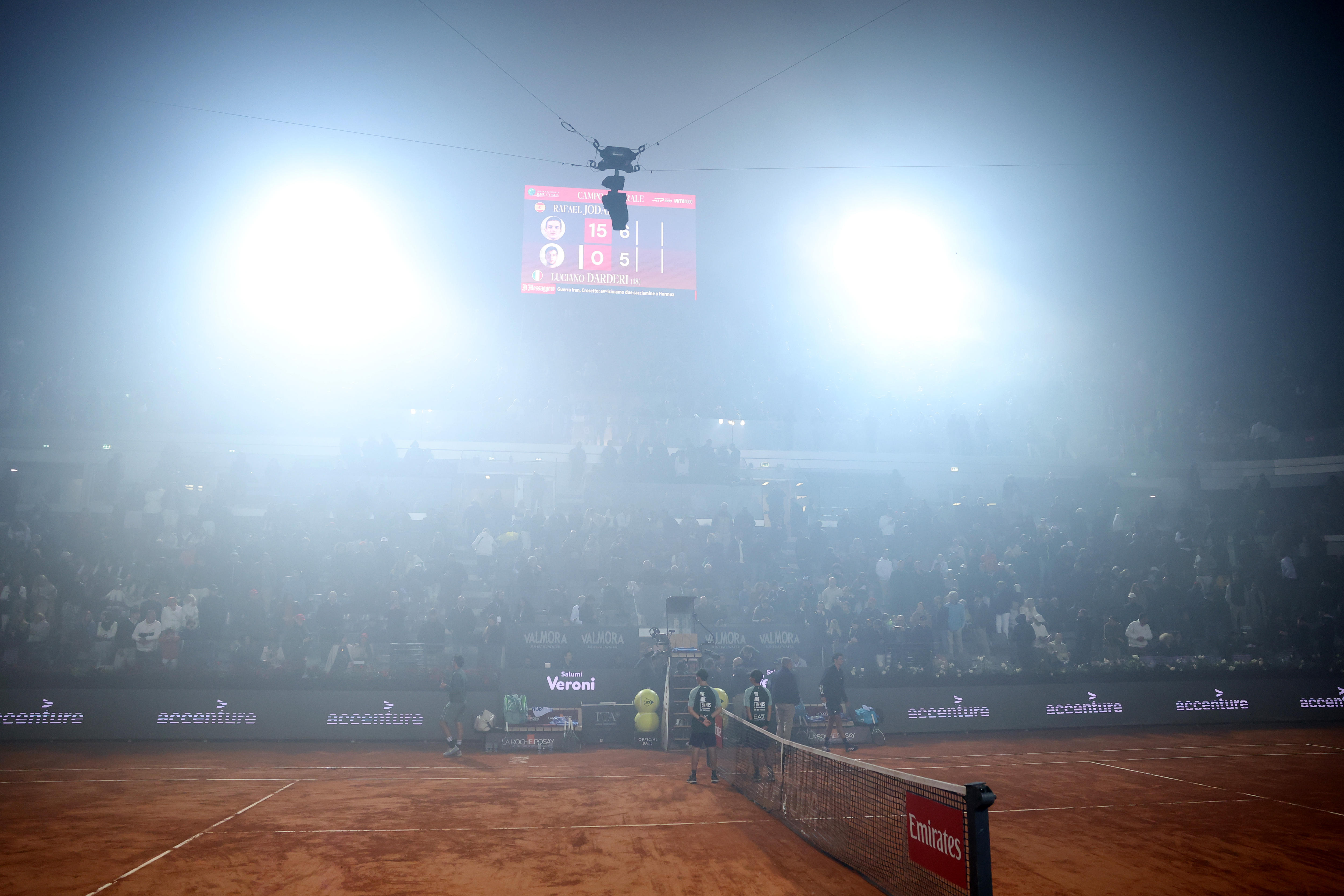 Firework smoke creates a haze at the tennis