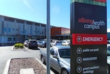 A sign showing the way to the emergency department, car park and radiology at Albany Health Campus.
