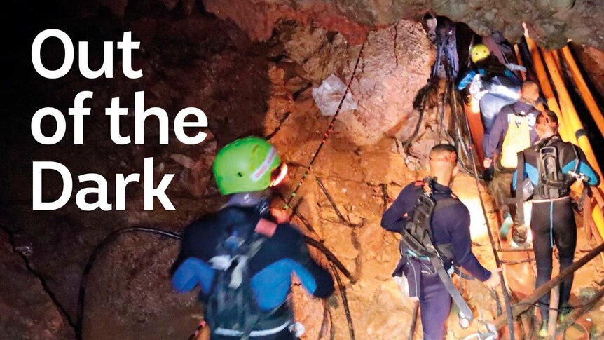 Cavers entering cave system with rescue equipment