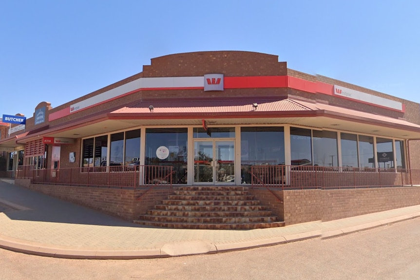 A brick bank branch on a street corner.