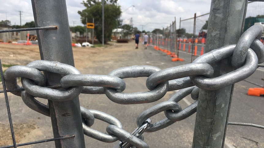 a lock on a gate at a building site