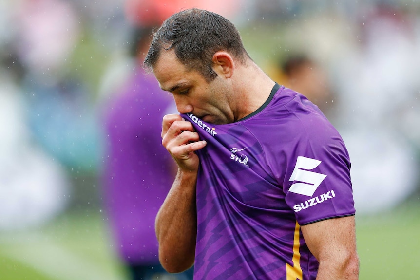 A Melbourne NRL player wipes his nose with his warm-up shirt before a match.
