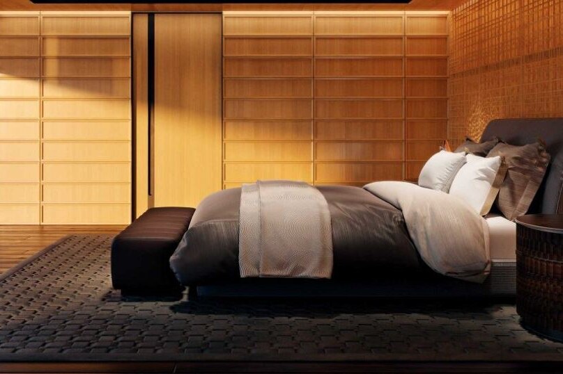 A bed in a room panelled with wood