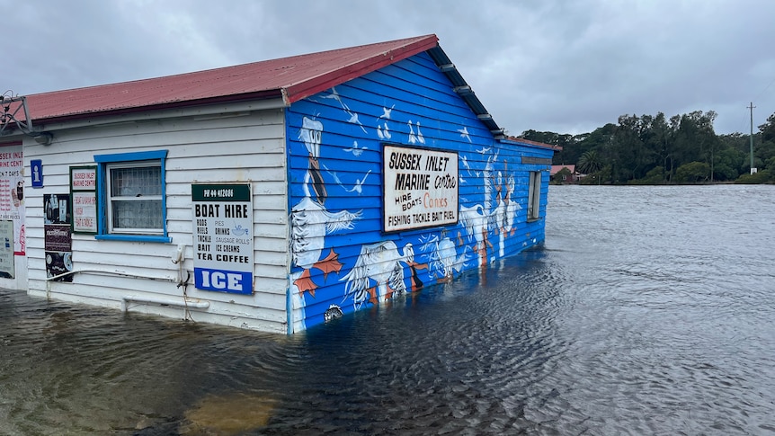 A bait and tackle shop is inundated by flood waters at Sussex Inlet.