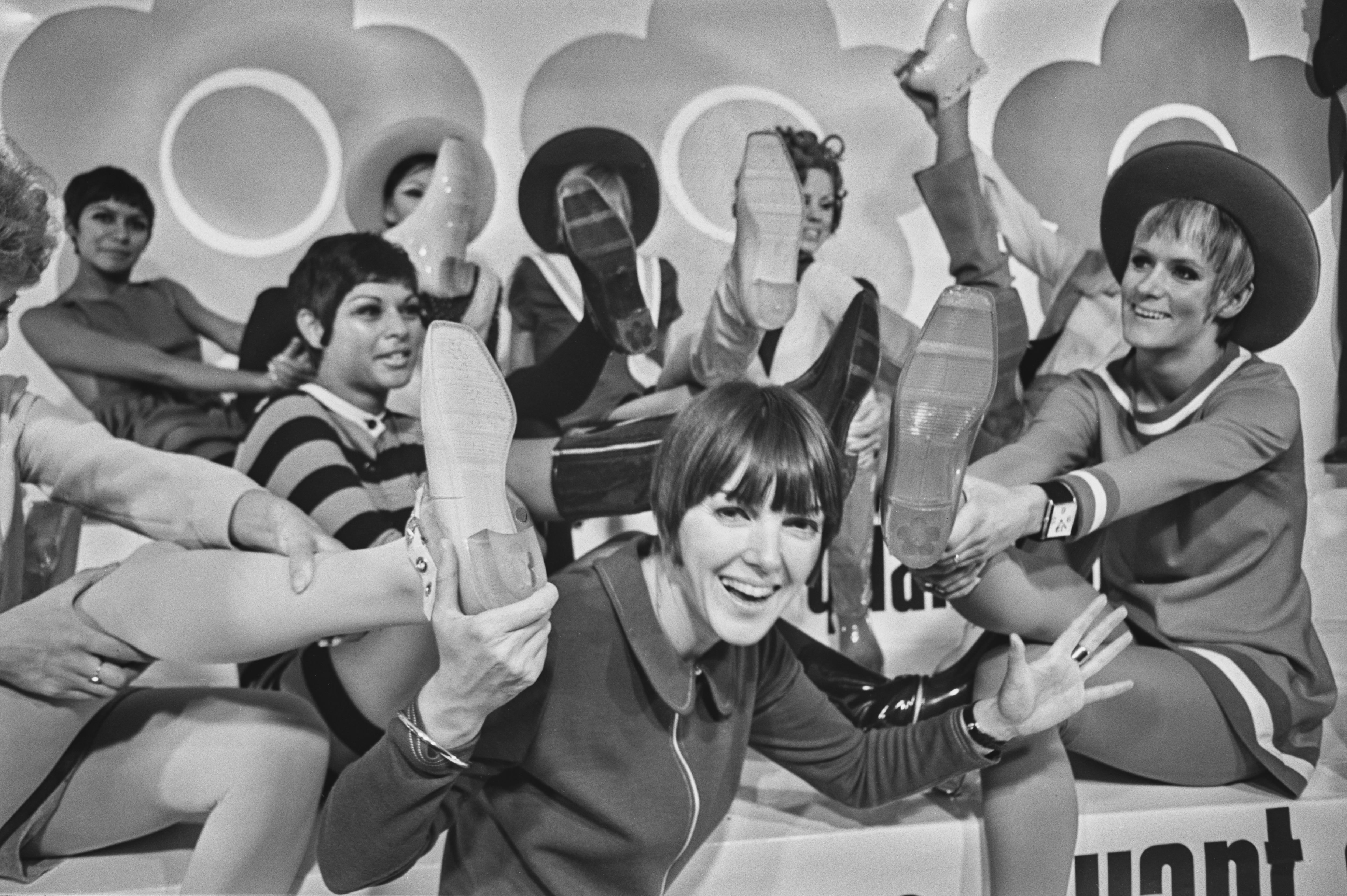 Mary Quant surrounded by shoes and models