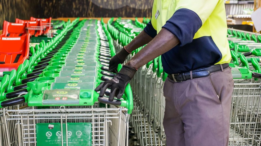 Up-close shot of hands pushing trolleys.