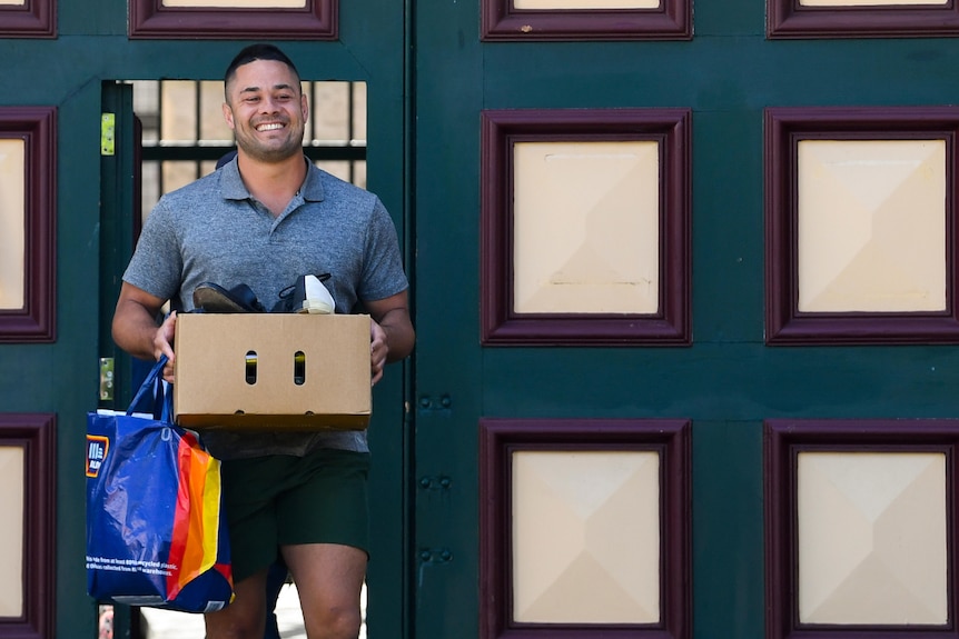 A man holding a box walking 