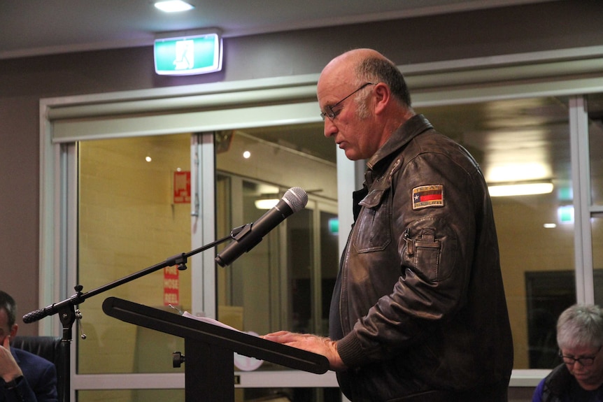 A man speaks at a council meeting