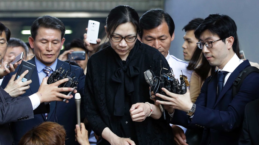 Former Korean Air executive Cho Hyun-ah is surrounded by reporters as she leaves the Seoul High Court in Seoul.