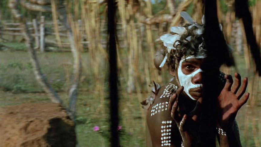 Actor David Dalaithngu, an young Yolngu man in traditional paint dancing, in the 1971 film Walkabout