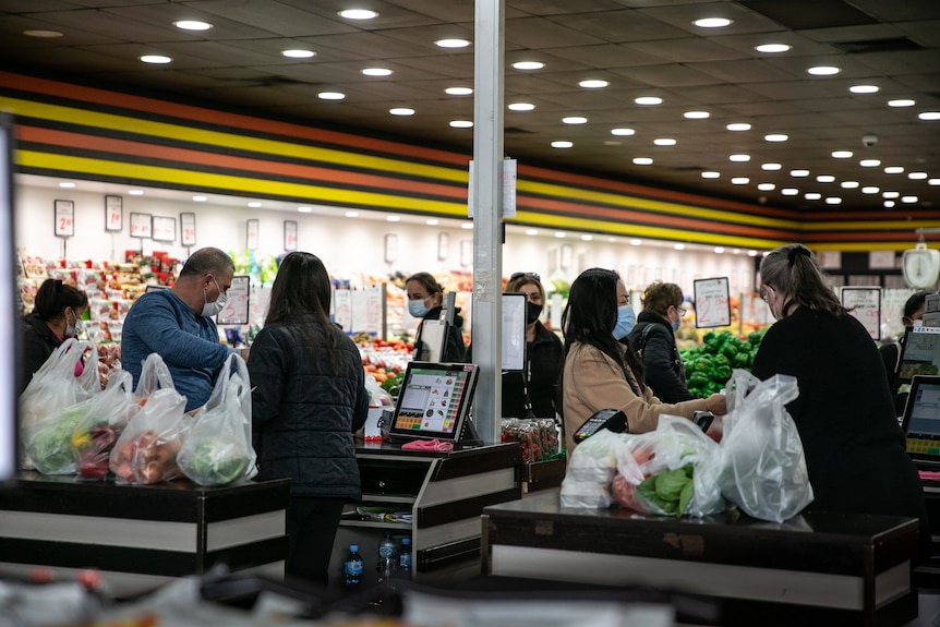 Shoppers at a supermarket check-out. 