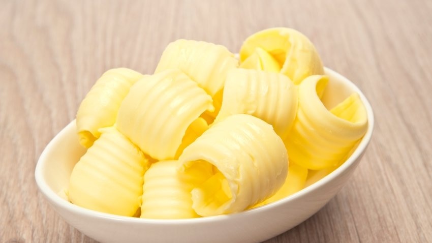 A small bowl filled with curls of butter.