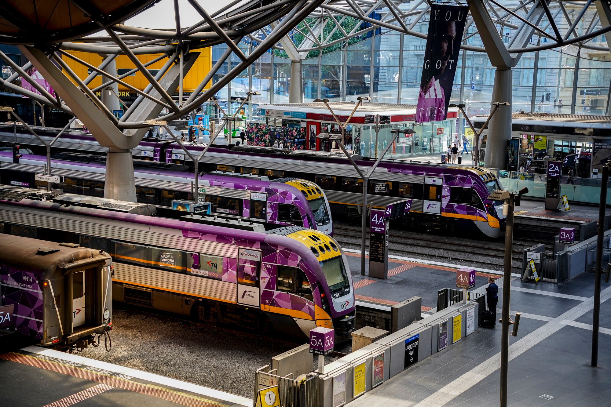 Southern Cross train platform where you can see about three platforms and four trains