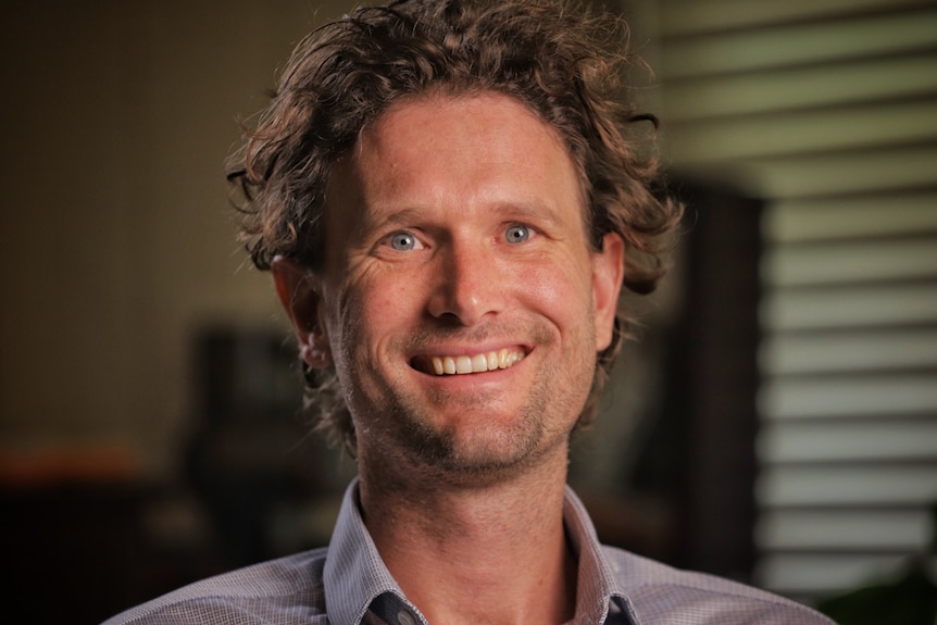 Head shot de l'économiste Cameron Murray, souriant à la caméra