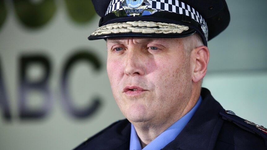 A tight head and shoulders shot of WA Police Commissioner Col Blanch speaking while wearing his police uniform.
