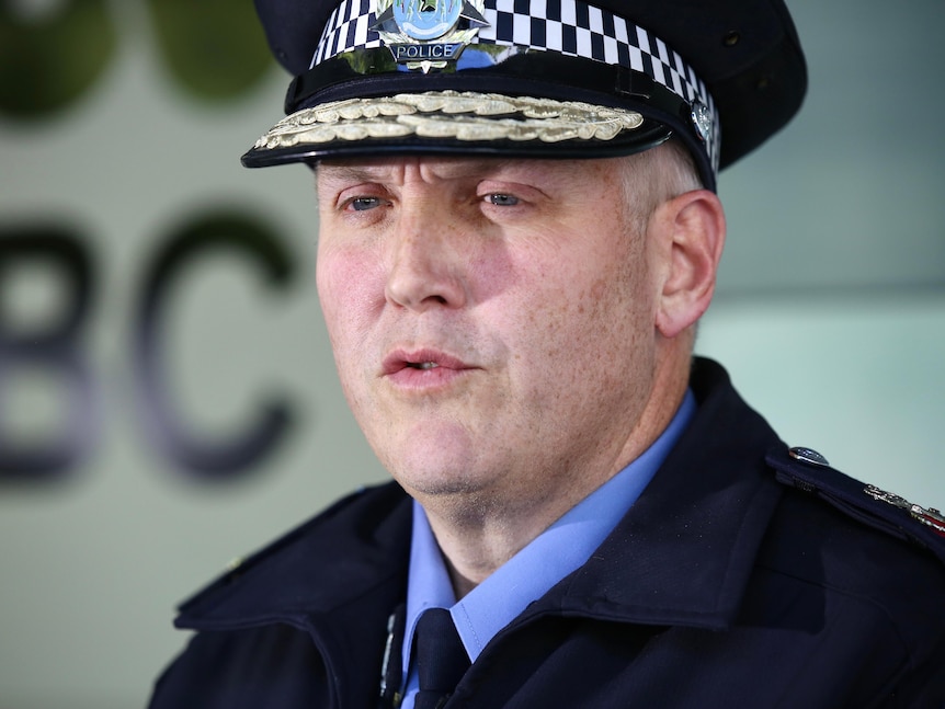 A tight head and shoulders shot of WA Police Commissioner Col Blanch speaking while wearing his police uniform.