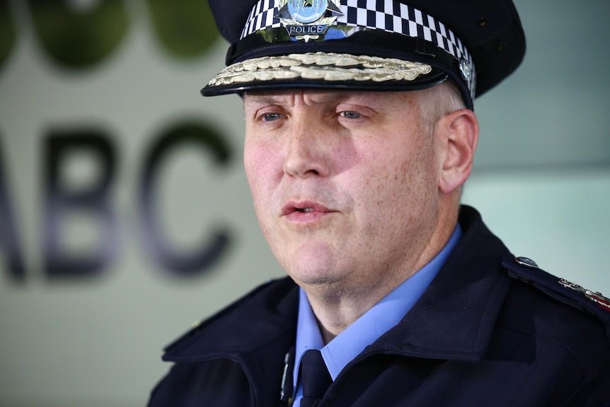 A tight head and shoulders shot of WA Police Commissioner Col Blanch speaking while wearing his police uniform.