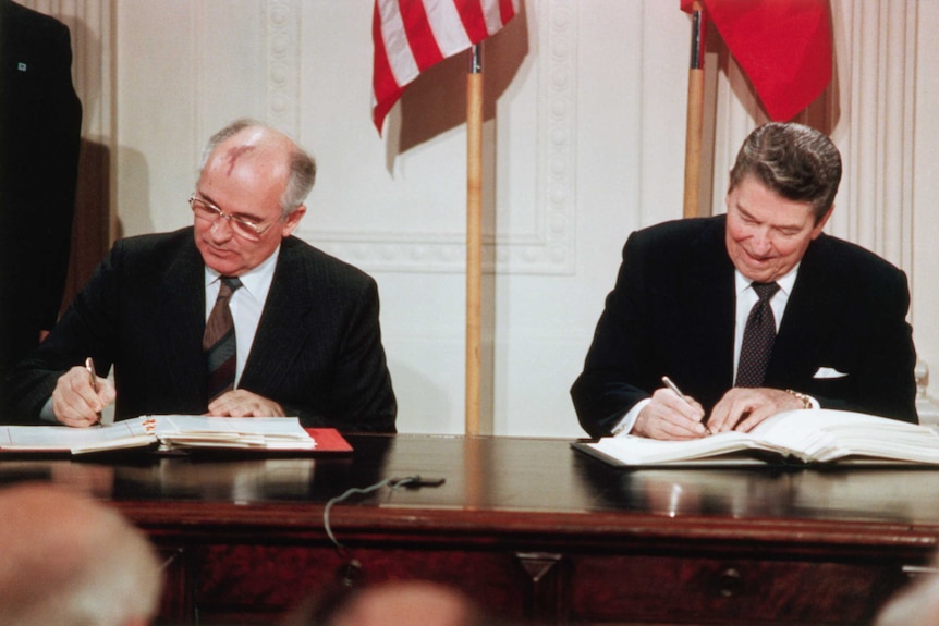Ronald Reagan signs a treaty with the Soviet Union in 1987