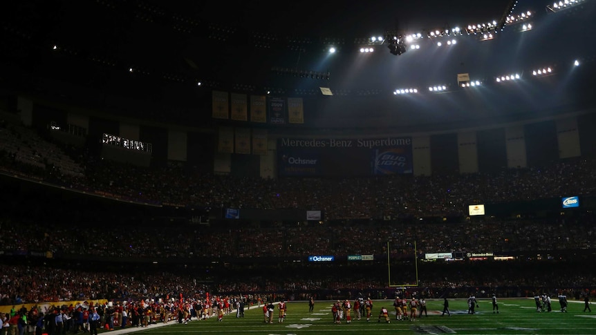 Players mill around after lights out at Super Bowl XLVII.