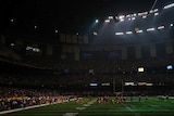 Players mill around after lights out at Super Bowl XLVII.