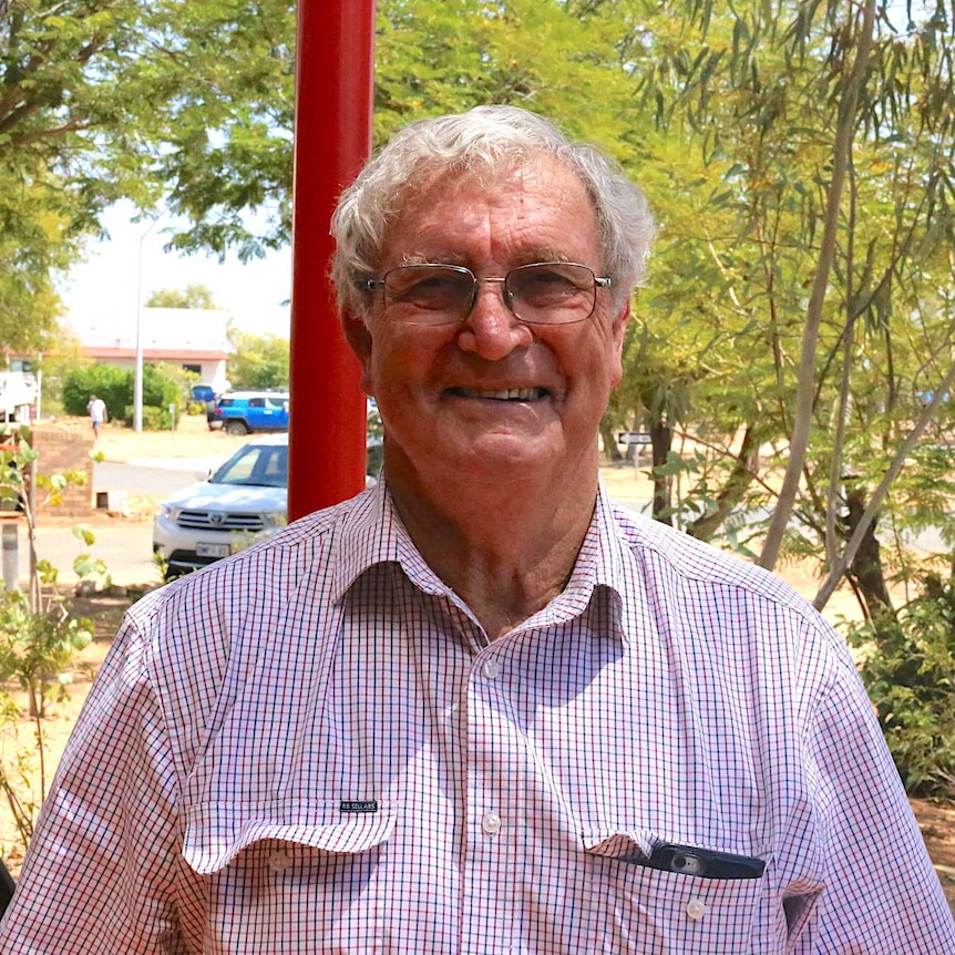 a man in front oftrees