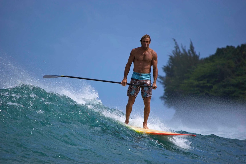Laird Hamilton on a paddle board