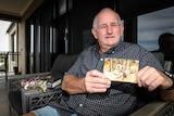 John Young from Bendigo at home with a photo of him during the Vietnam War.