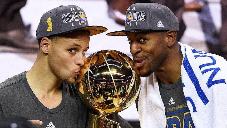 Steph Curry, Andre Iguodala celebrate with trophy after Golden State beats Cleveland for NBA title.