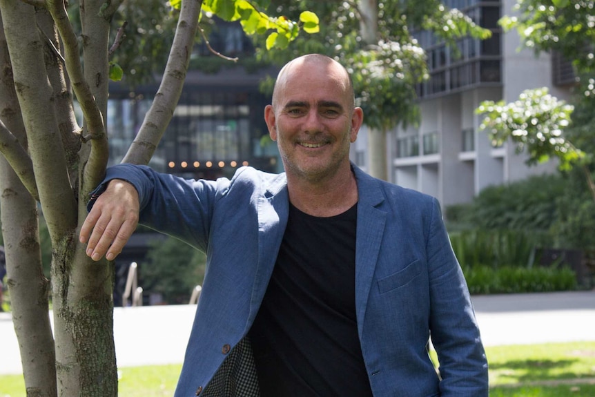 Mike Horne stands in the green space of One Central Park