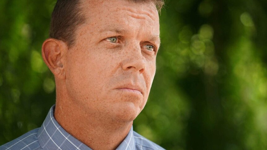 Headshot of Detective Sergeant Matt Allen in front of a green background.