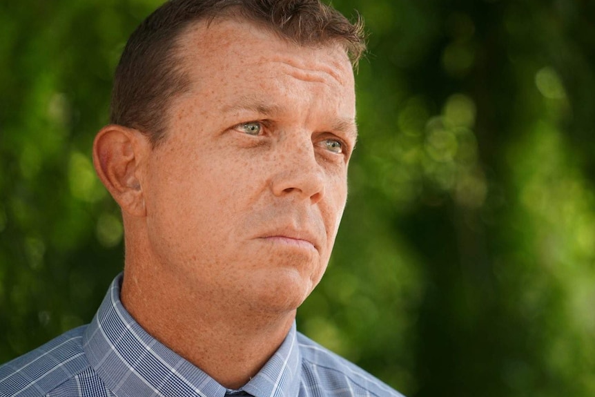 Headshot of Detective Sergeant Matt Allen in front of a green background.