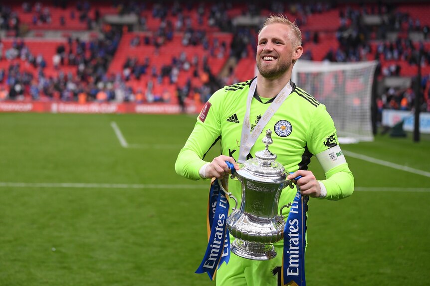 Kasper Schmeichel holds the FA Cup