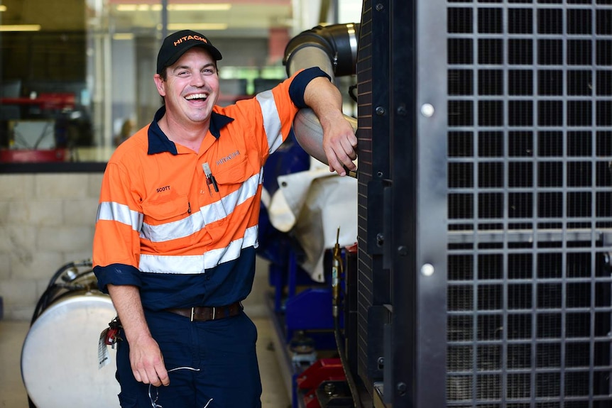 Adult apprentice Scott McGuire, 38, smiling at his Brisbane workplace.