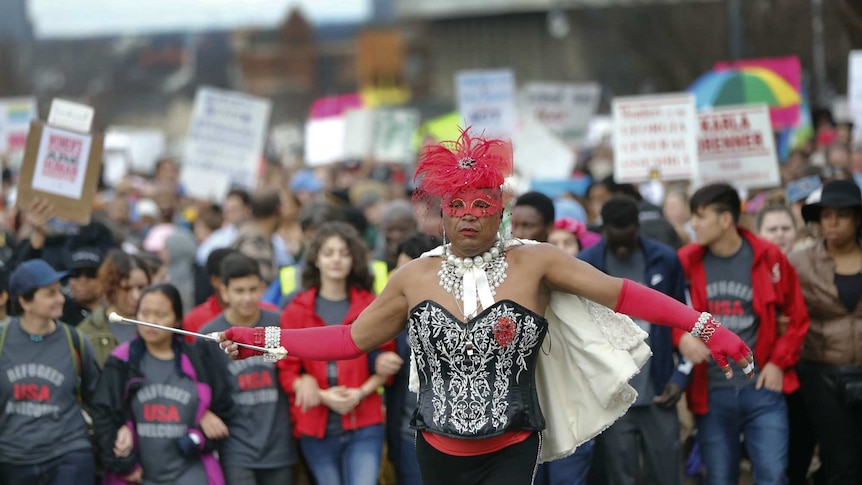 A man in drag leads the Women's March in Atlanta.