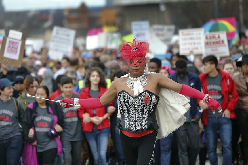 A man in drag leads the Women's March in Atlanta.