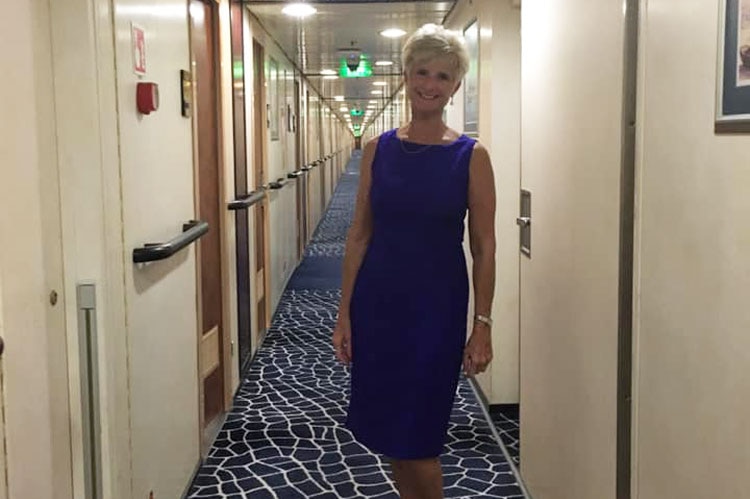 Woman dressed up in blue dress for #FormalFriday on a cruise ship.