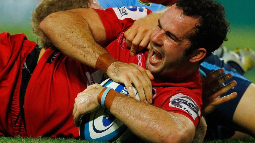 Try time ... Jono Lance celebrates his try against the Bulls.