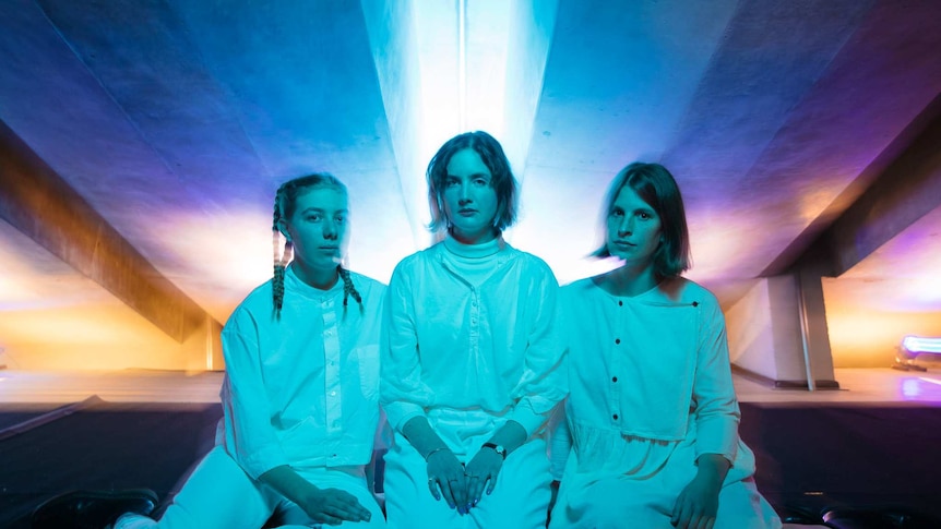 The Alaska Orchestra - Three women in white clothes - bathed in ethereal light at the Sydney Opera House