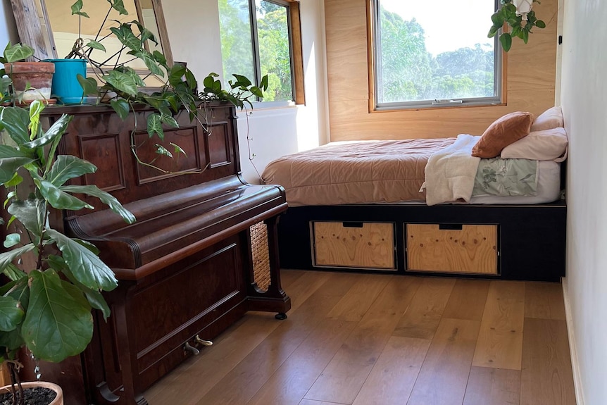 An old wooden piano with plants on it 