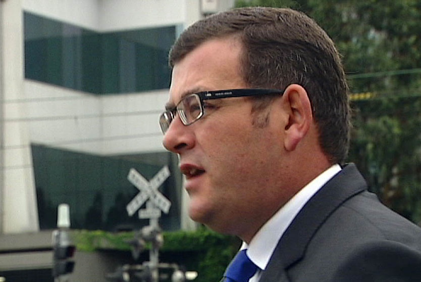 Andrews defends cost of removing level crossings