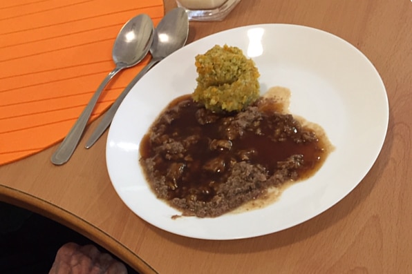 Green mash and brown mince in gravy.