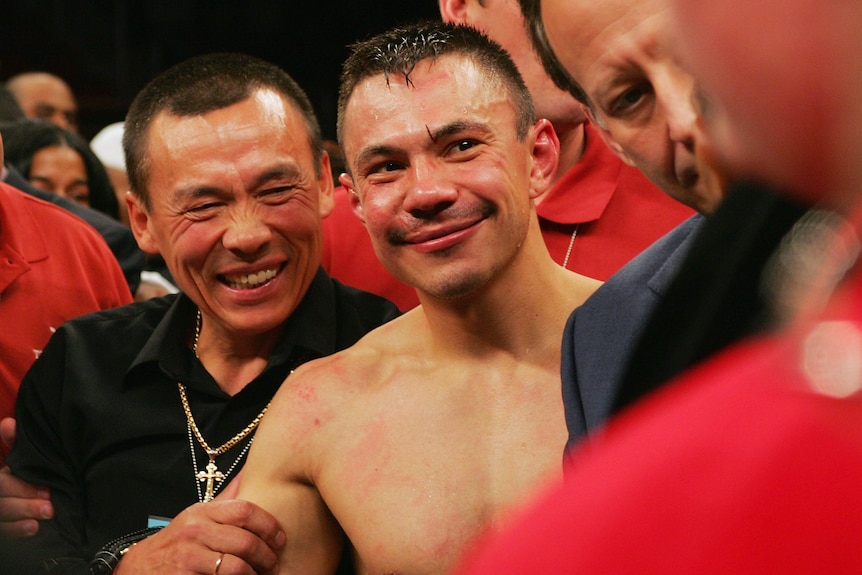 Boris and Kostya Tszyu smile in the ring after a boxing bout.